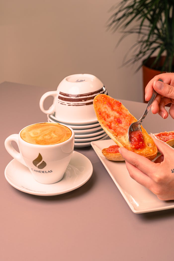 A close-up of toast with jam and coffee, perfect for a breakfast setting.